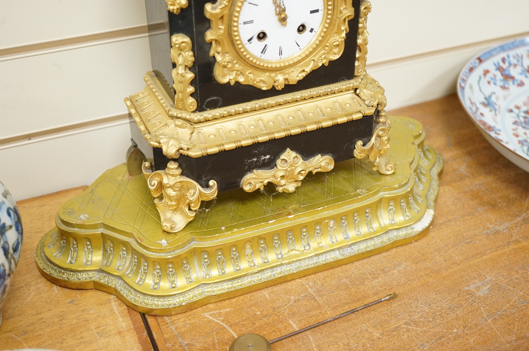 A 19th century French gilt metal mantel clock and stand, 56cm total